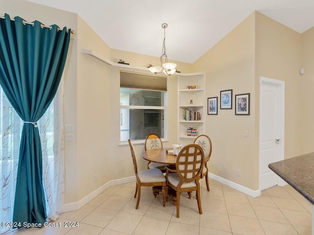 dining space featuring built in shelves, an inviting chandelier, and light tile patterned floors