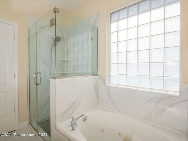 bathroom featuring shower with separate bathtub and plenty of natural light