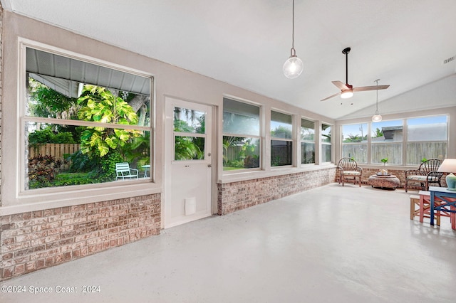 sunroom / solarium with ceiling fan, a healthy amount of sunlight, and lofted ceiling