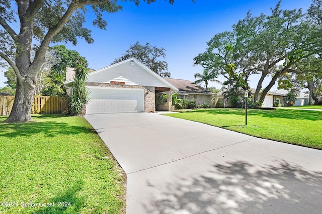 single story home featuring a garage and a front lawn