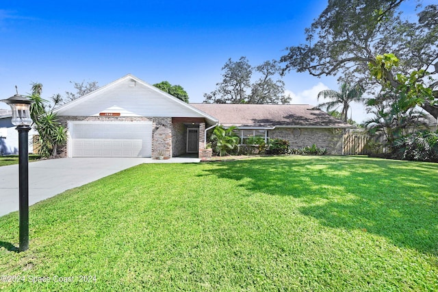 single story home featuring a front yard and a garage