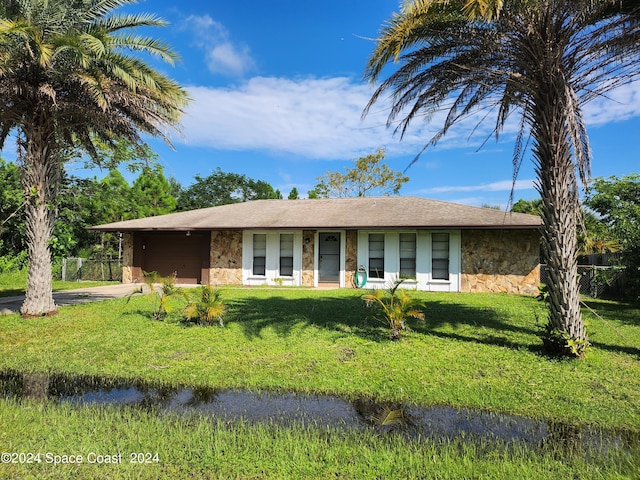 ranch-style home with a front lawn