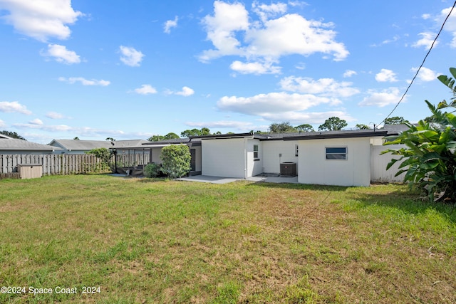 rear view of house with a yard