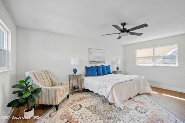 bedroom with wood-type flooring and ceiling fan