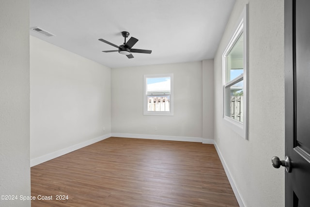 spare room with ceiling fan and hardwood / wood-style flooring