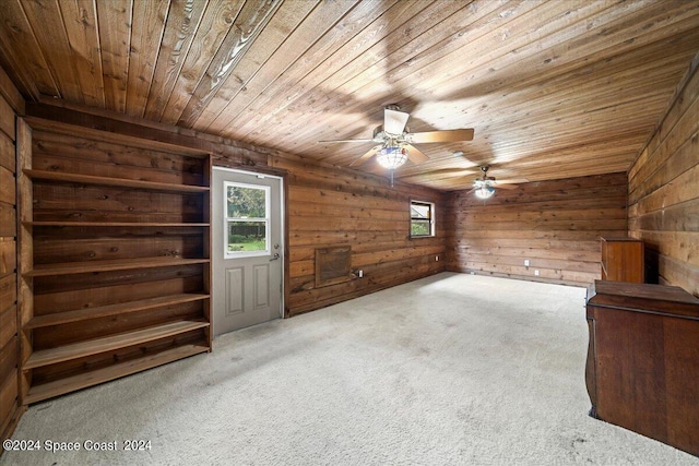 bonus room with wood walls, ceiling fan, wooden ceiling, and light carpet