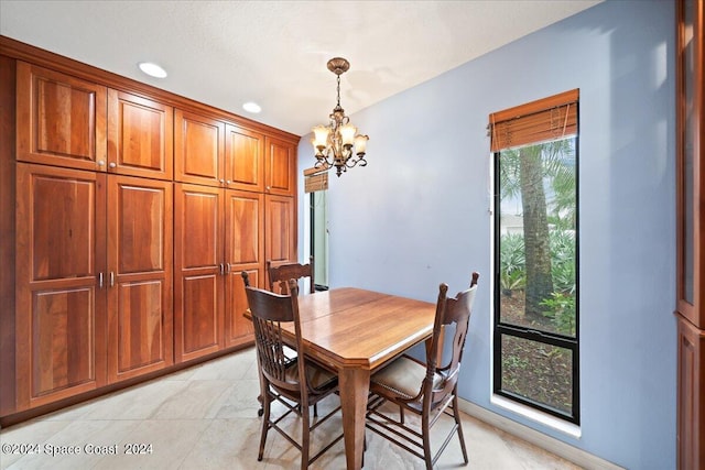 dining area featuring an inviting chandelier and light tile patterned floors