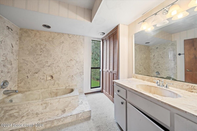 bathroom with vanity and a bath