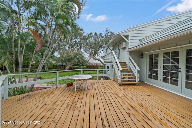 wooden deck with french doors and a yard