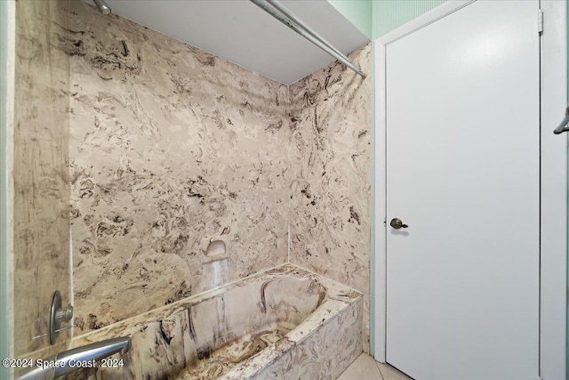 bathroom with bathing tub / shower combination and tile patterned flooring