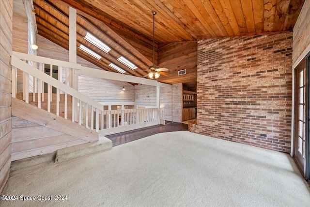 spare room with wood ceiling, a skylight, high vaulted ceiling, and ceiling fan