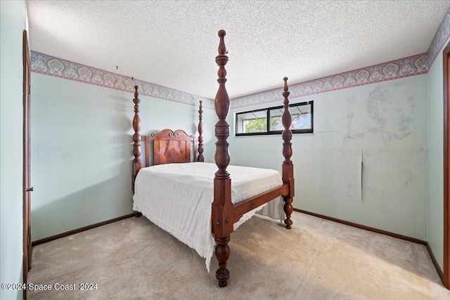 carpeted bedroom featuring a textured ceiling