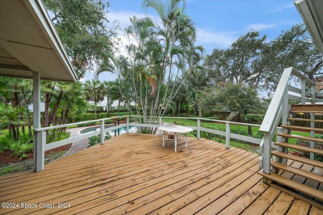 wooden terrace featuring a fenced in pool