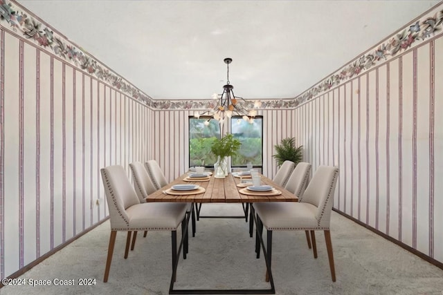 carpeted dining area with a chandelier