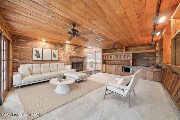 living room with ceiling fan, wooden ceiling, and brick wall