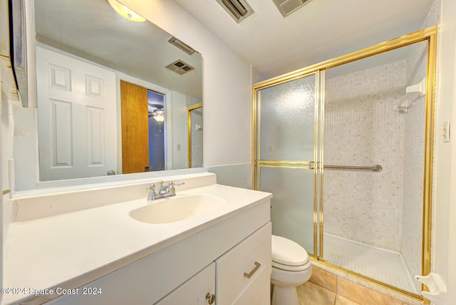 bathroom with walk in shower, vanity, toilet, and tile patterned floors