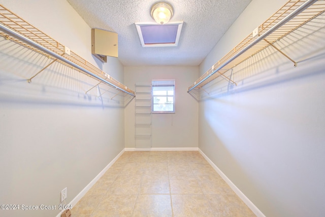 spacious closet featuring tile patterned floors