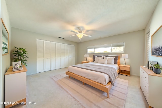 bedroom featuring ceiling fan and light colored carpet