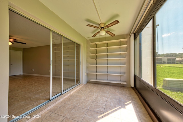 unfurnished sunroom with ceiling fan and plenty of natural light