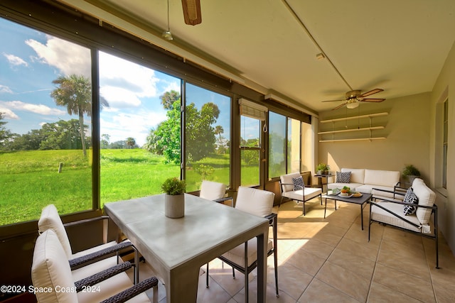 sunroom featuring ceiling fan