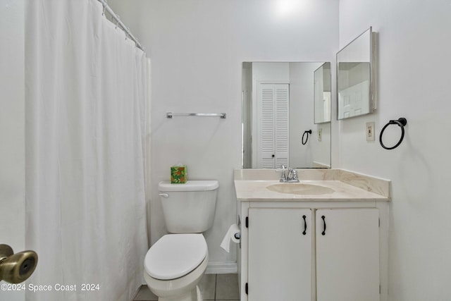 bathroom featuring vanity, toilet, and tile patterned floors