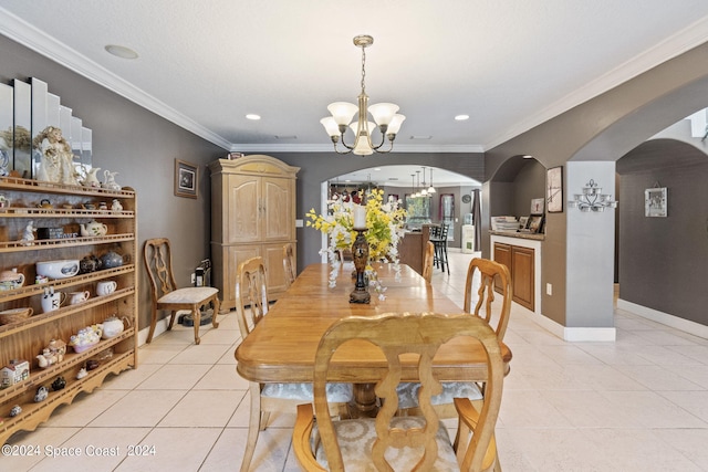 tiled dining room featuring a notable chandelier and crown molding