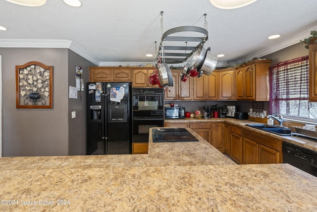 kitchen featuring ornamental molding, a textured ceiling, sink, and black appliances