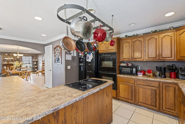 kitchen with a textured ceiling, black appliances, crown molding, and light tile patterned floors