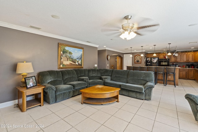 tiled living room with a textured ceiling, ceiling fan, and crown molding