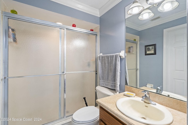 bathroom featuring vanity, crown molding, toilet, and an enclosed shower