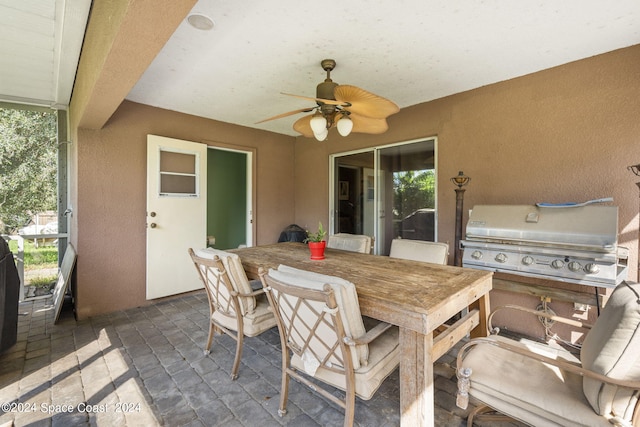 view of patio featuring area for grilling, ceiling fan, and a grill