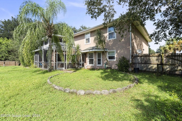 rear view of property with a yard