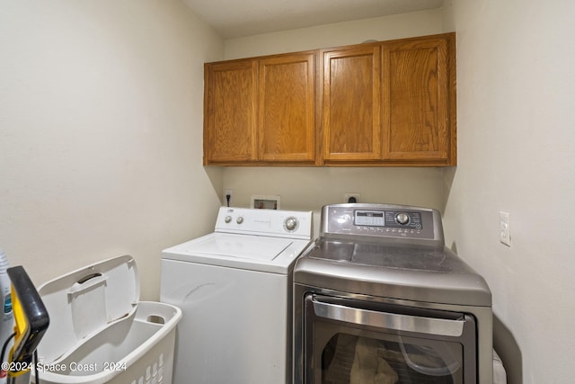 laundry area featuring cabinets and washer and clothes dryer