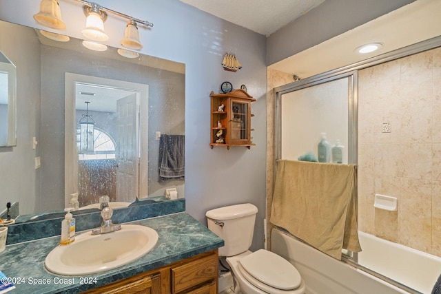 full bathroom with enclosed tub / shower combo, vanity, toilet, and an inviting chandelier