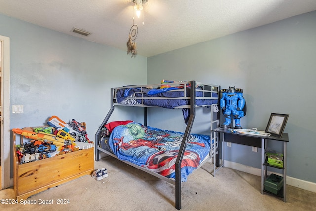 carpeted bedroom with a textured ceiling