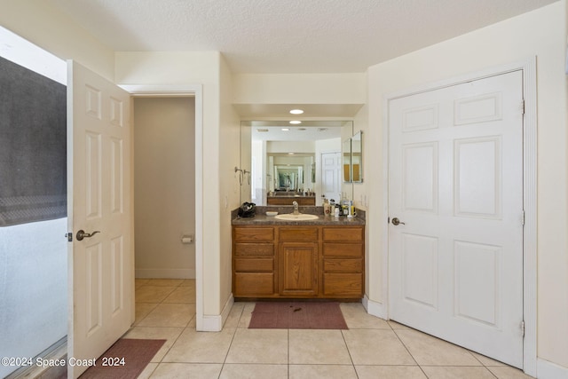 bathroom featuring vanity, a textured ceiling, and tile patterned floors