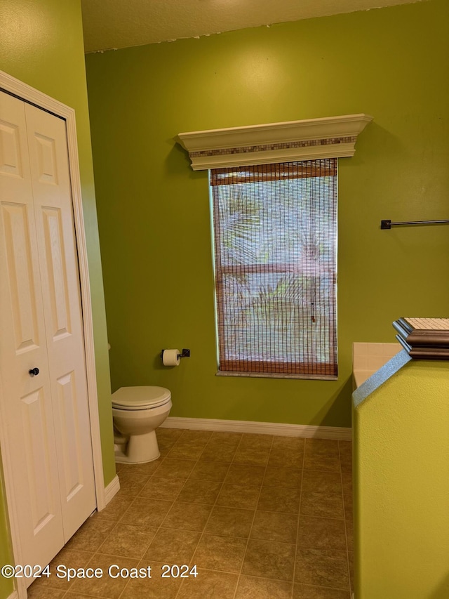 1870 Parrsboro St NW, Palm Bay, FL 32907 - bathroom featuring baseboards, tile patterned flooring, a closet, and toilet