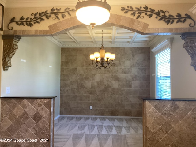 1870 Parrsboro St NW, Palm Bay, FL 32907 - unfurnished dining area featuring coffered ceiling, tile walls, beam ceiling, crown molding, and a notable chandelier