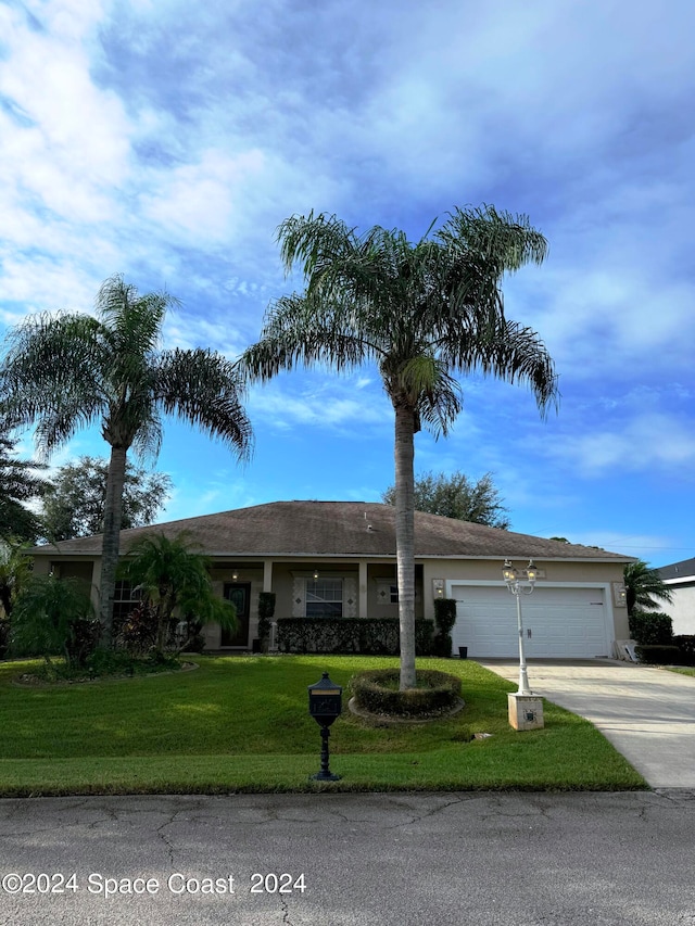 ranch-style house featuring a garage and a front yard