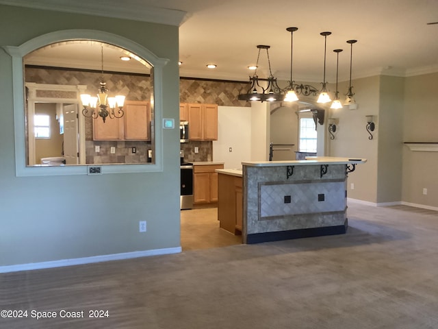 kitchen featuring light brown cabinets, decorative light fixtures, crown molding, and stainless steel appliances