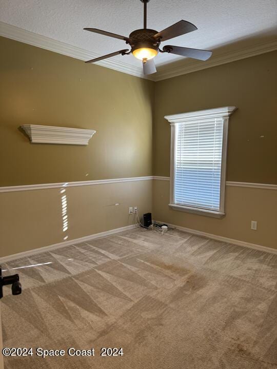 1870 Parrsboro St NW, Palm Bay, FL 32907 - carpeted empty room featuring a ceiling fan, baseboards, a textured ceiling, and ornamental molding