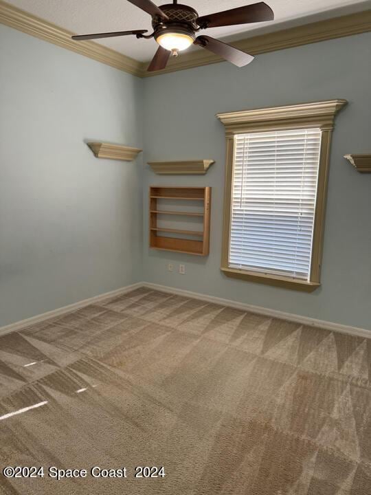 1870 Parrsboro St NW, Palm Bay, FL 32907 - unfurnished room featuring carpet, crown molding, baseboards, and a ceiling fan