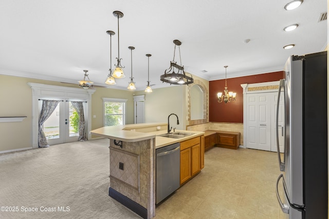 1870 Parrsboro St NW, Palm Bay, FL 32907 - kitchen with stainless steel appliances, a chandelier, brown cabinetry, open floor plan, and french doors