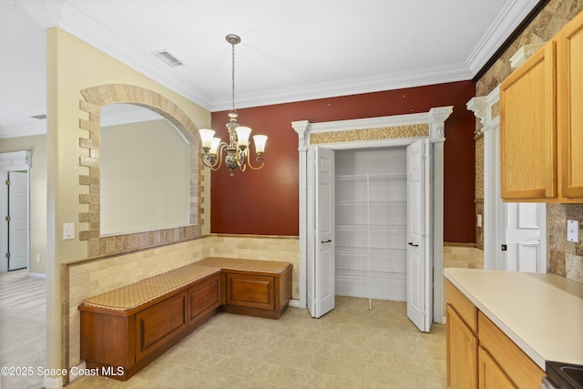 1870 Parrsboro St NW, Palm Bay, FL 32907 - unfurnished dining area featuring crown molding, a chandelier, and arched walkways