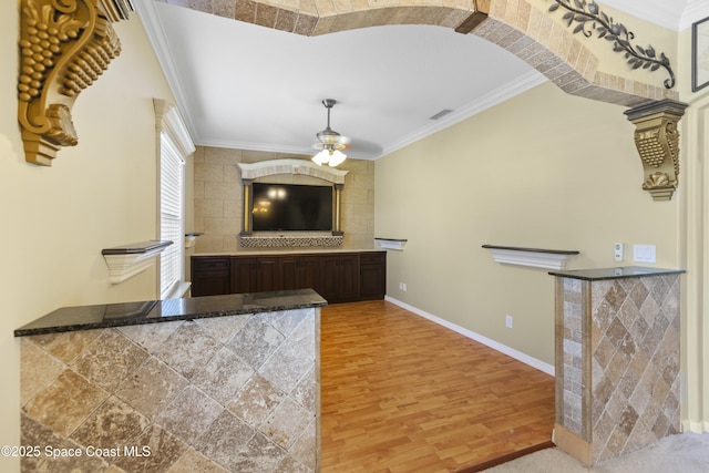 1870 Parrsboro St NW, Palm Bay, FL 32907 - bar with light wood-type flooring, tasteful backsplash, a ceiling fan, ornamental molding, and arched walkways