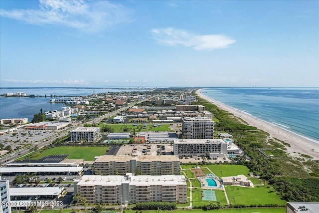 drone / aerial view featuring a water view and a beach view