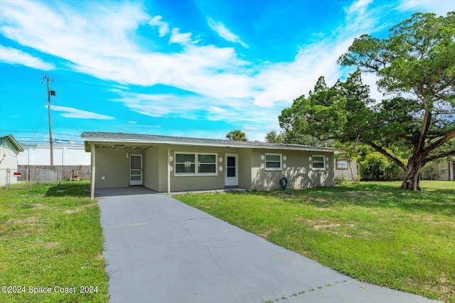 ranch-style house with a front lawn and a carport