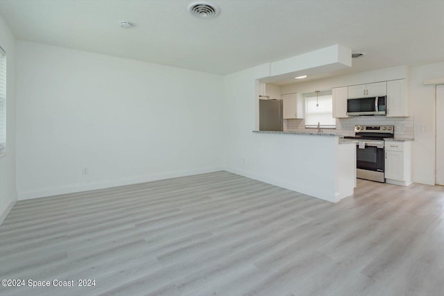 kitchen with kitchen peninsula, light hardwood / wood-style flooring, stainless steel appliances, and white cabinets