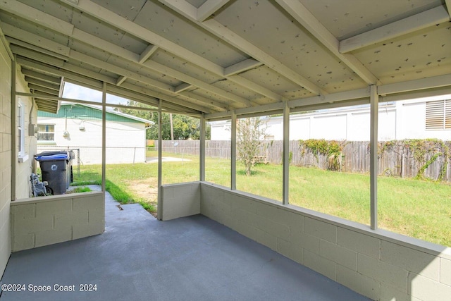 unfurnished sunroom with vaulted ceiling and a wealth of natural light