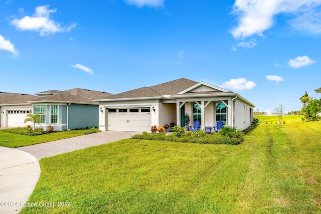 view of front of home featuring a front yard and a garage